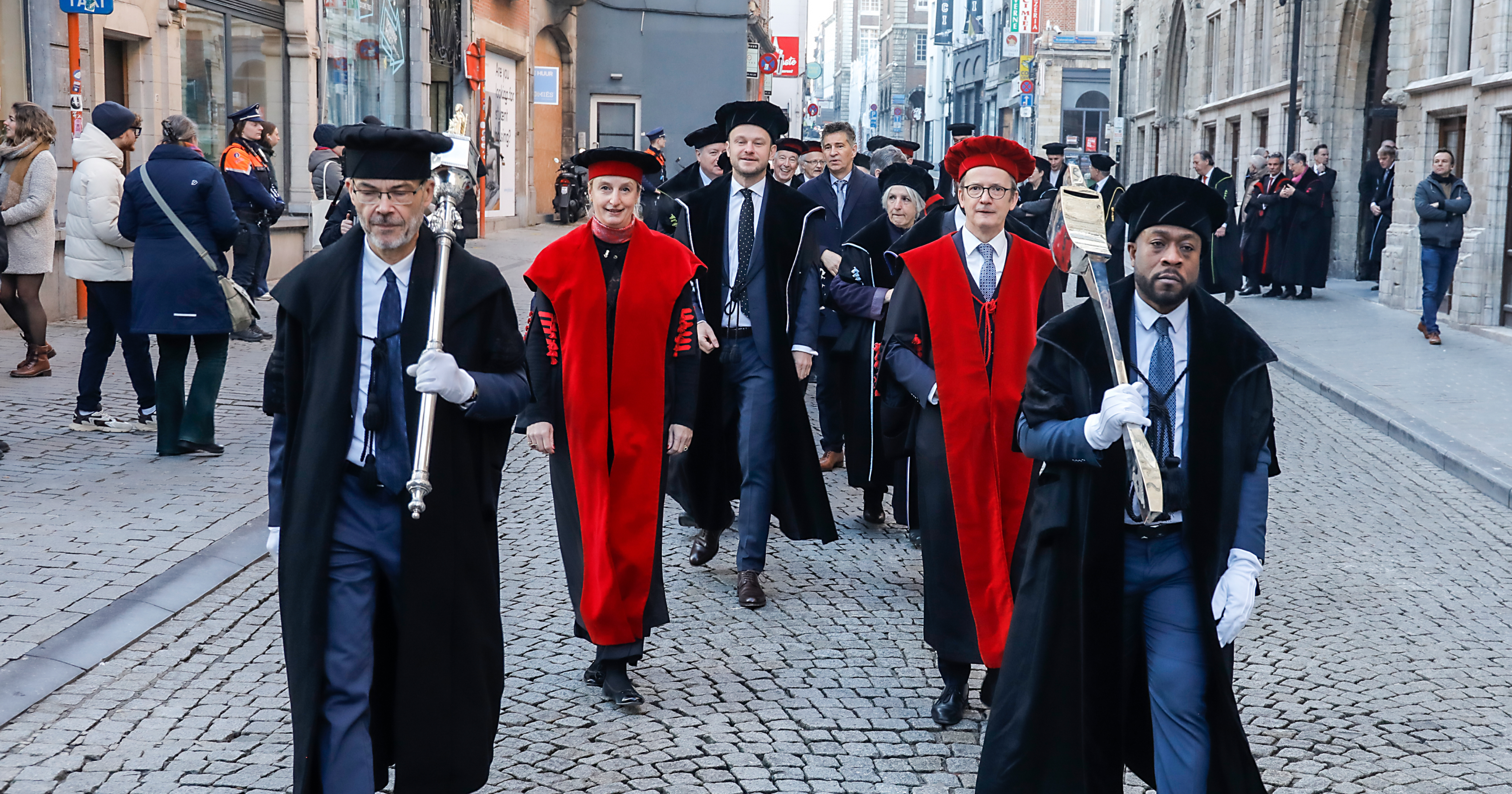 A photo of Max Roser and others marching through town as part of the ceremony for receiving an honorary doctorate from KU Leuven and UCLouvain in Belgium. The photo is copyright KU Leuven - Rob Stevens.